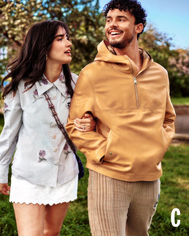 Asha Banks and Matthew Broome walking arm in arm outdoors, dressed in stylish casual editorial fashion.