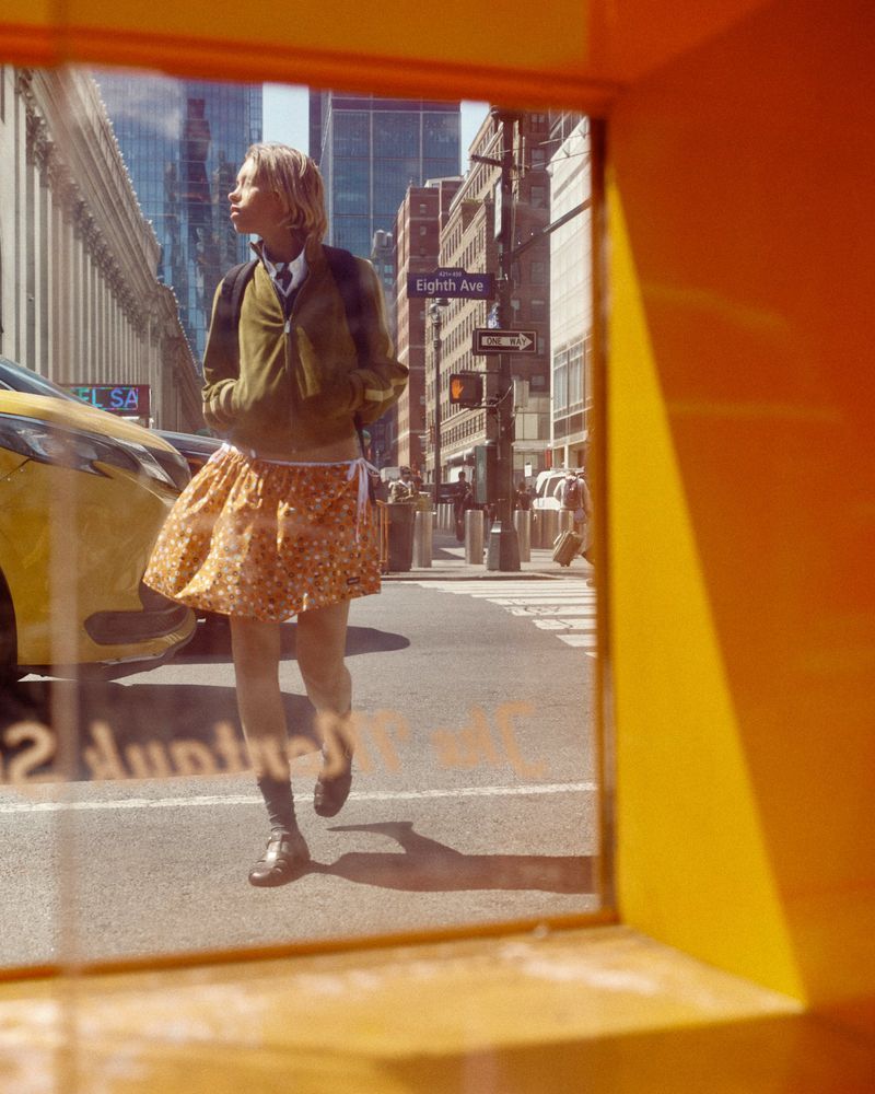Model Lena Mantler walking down a city street near a yellow cab in CAP 74024 editorial