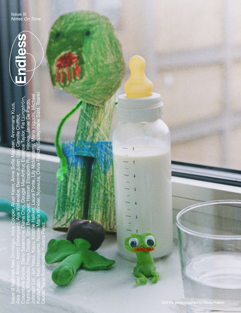 Magazine cover featuring a drawing of a green monster, a baby bottle filled with milk, and a clay figure, set against a window.