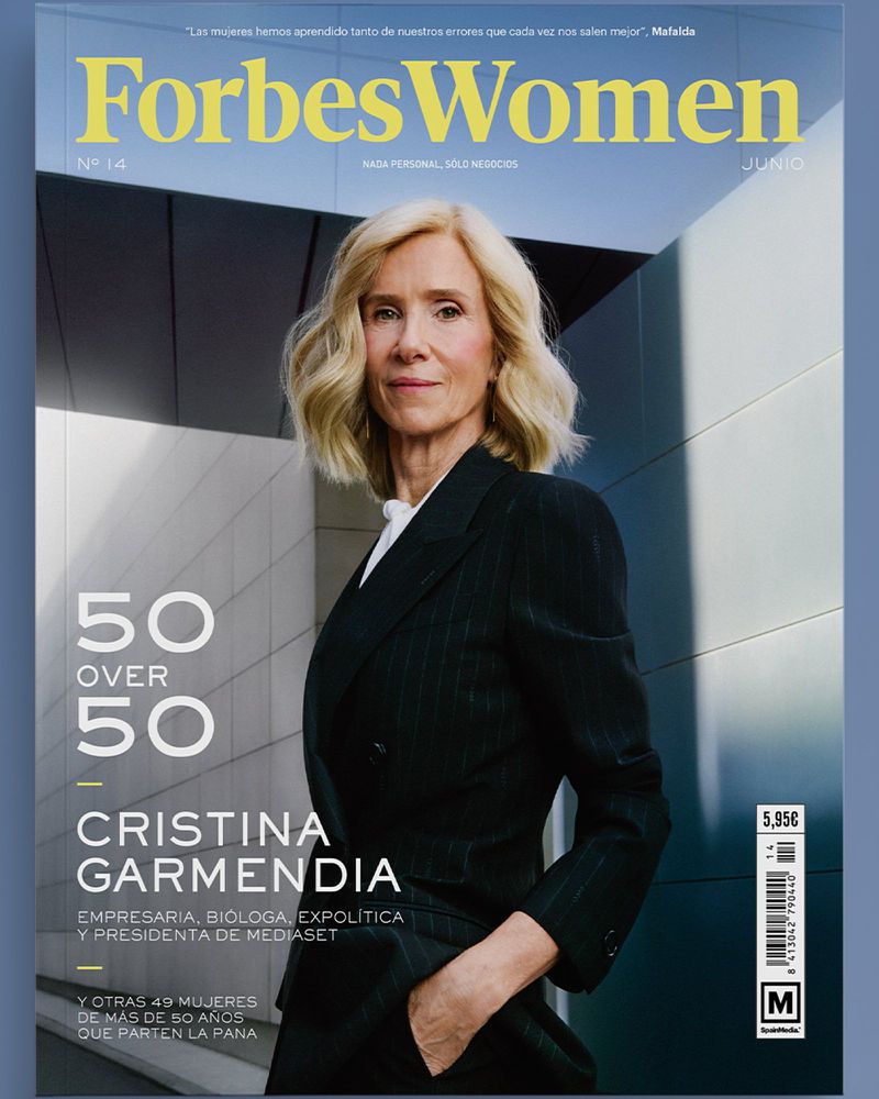 Magazine cover featuring a blonde woman in a pinstripe suit. Text reads Forbes Women, 50 over 50, and Cristina Garmendia against a modern building backdrop.