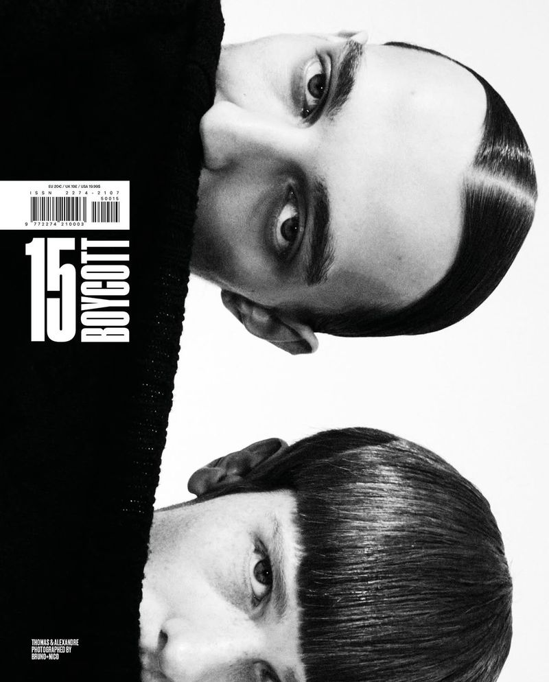 Black-and-white magazine cover features two men's faces, one upside down, stark lighting, minimal text, fashion-forward and contemporary.