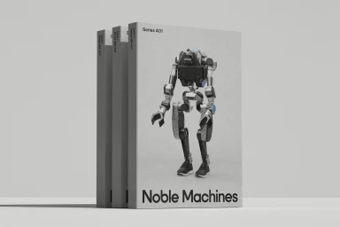 Three grey Noble Machines Series A01 brand identity books featuring a bipedal robot graphic standing on a seamless grey studio surface.