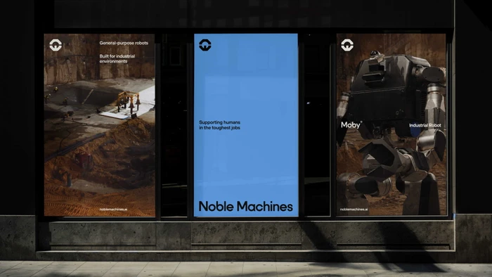 Three window display posters for Noble Machines robotics brand identity installed across a dark storefront glass facade.