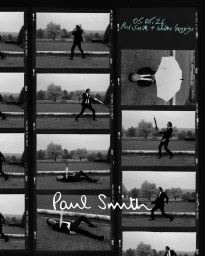 Black and white contact sheet of Walton Goggins posing with an umbrella in a dark suit on an estate lawn for Paul Smith.