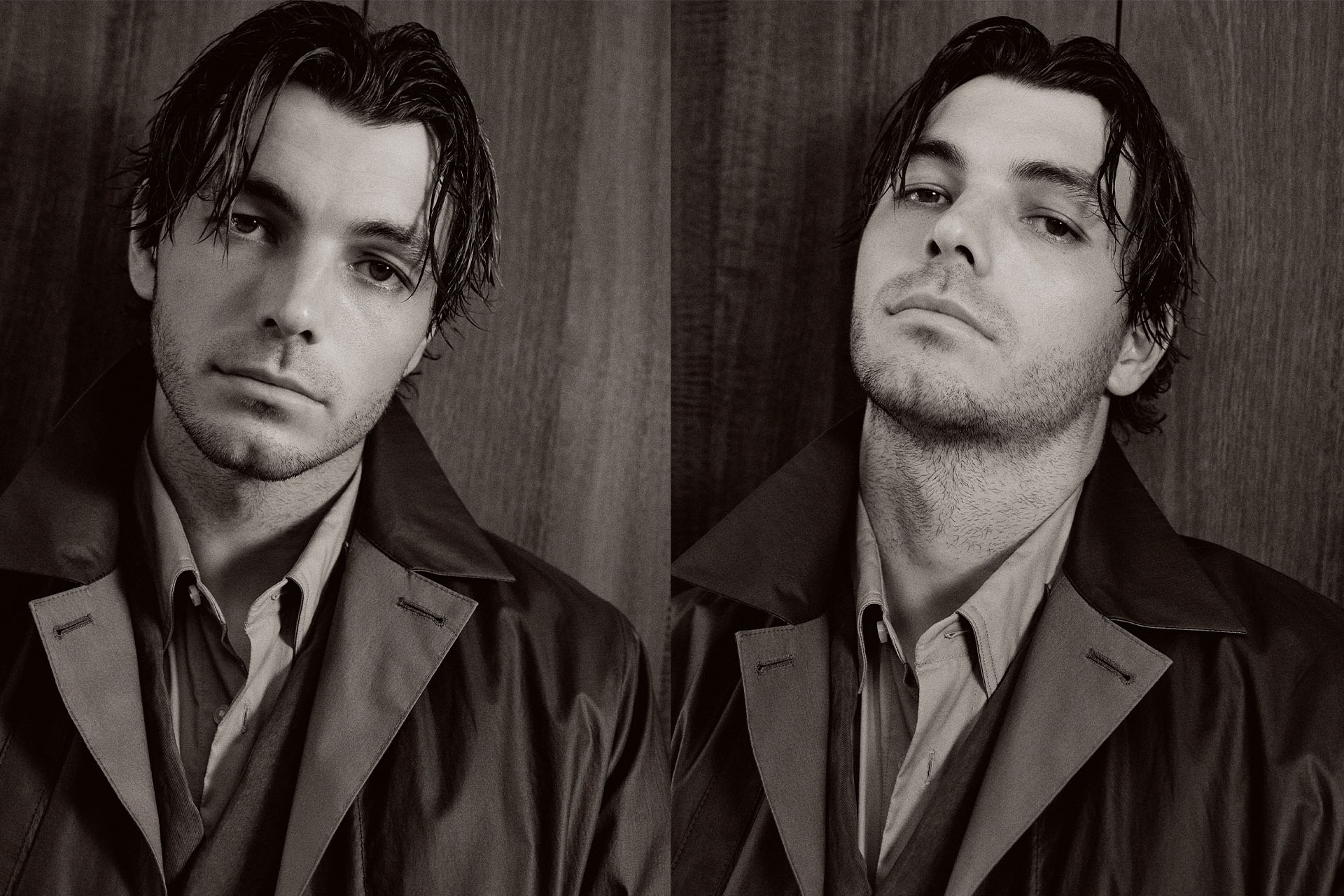 Monochrome portrait of a man in a collared shirt and jacket with dark hair, posing in front of a dark wooden panel background.