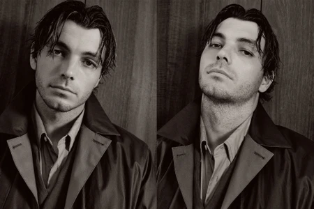 Portrait of Taylor Fritz for GQ Australia featuring dark clothing against a wood paneled wall