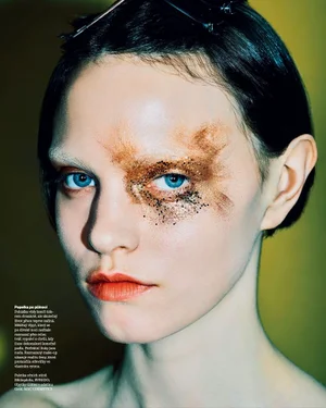 Close-up beauty portrait of model Lise Sauve wearing bronze glitter eye makeup for Vogue Czechoslovakia editorial.