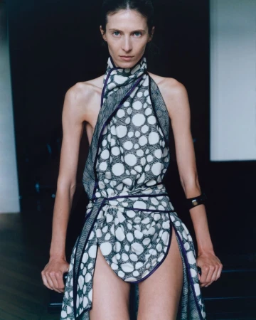 Model Martyna Budna wearing a printed halter dress with purple trim for Eloïse Brague.