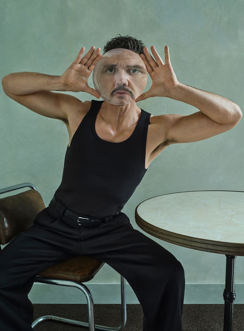 Man in a black tank top and pants is sitting on a chair with his hands up and a distorted image of his face in between.