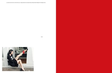 Magazine spread with a large solid red block on the right and a photo of Lily McMenamy seated with one leg raised on the bottom left.