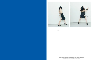 Magazine editorial spread featuring model Lily McMenamy posing in a beige top and black skirt beside a solid blue page.