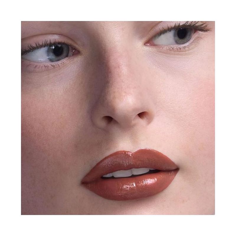 Close-up beauty portrait of model Viktoriia Afanasieva featuring glossy warm nude lipstick and natural skin texture.