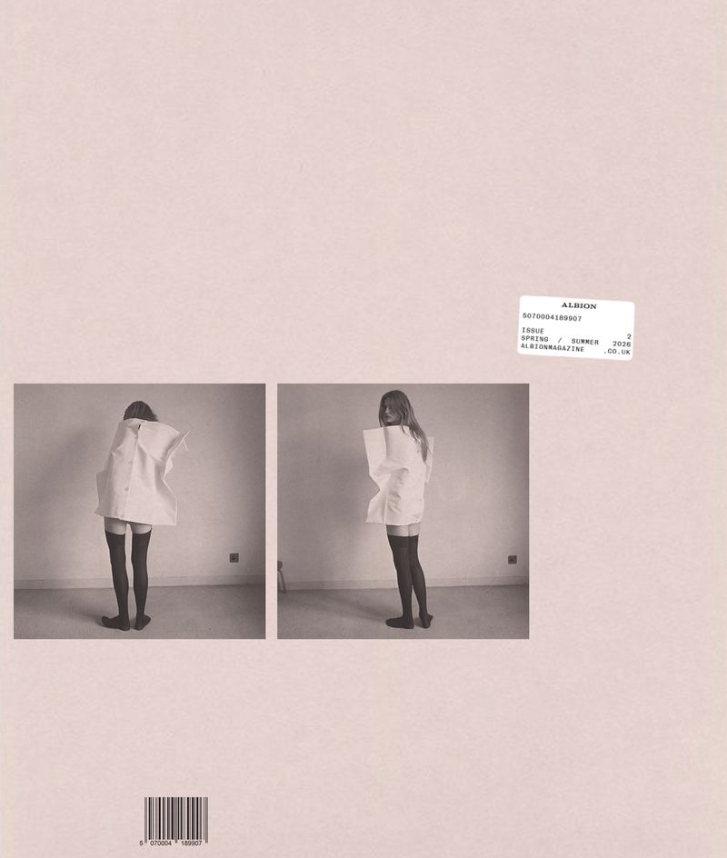 Magazine layout featuring two inset photographs of a model in a boxy white top and black thigh-high socks on a muted pink background.