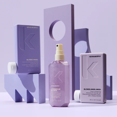 Kevin Murphy Blonde Angel and Shimmer Me Blonde hair care products displayed against a lavender backdrop with geometric shapes, studio lighting.