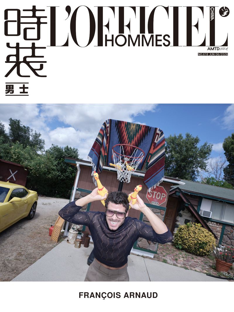 François Arnaud holding rubber chickens near his head for the L'Officiel Hommes China June 2026 cover.