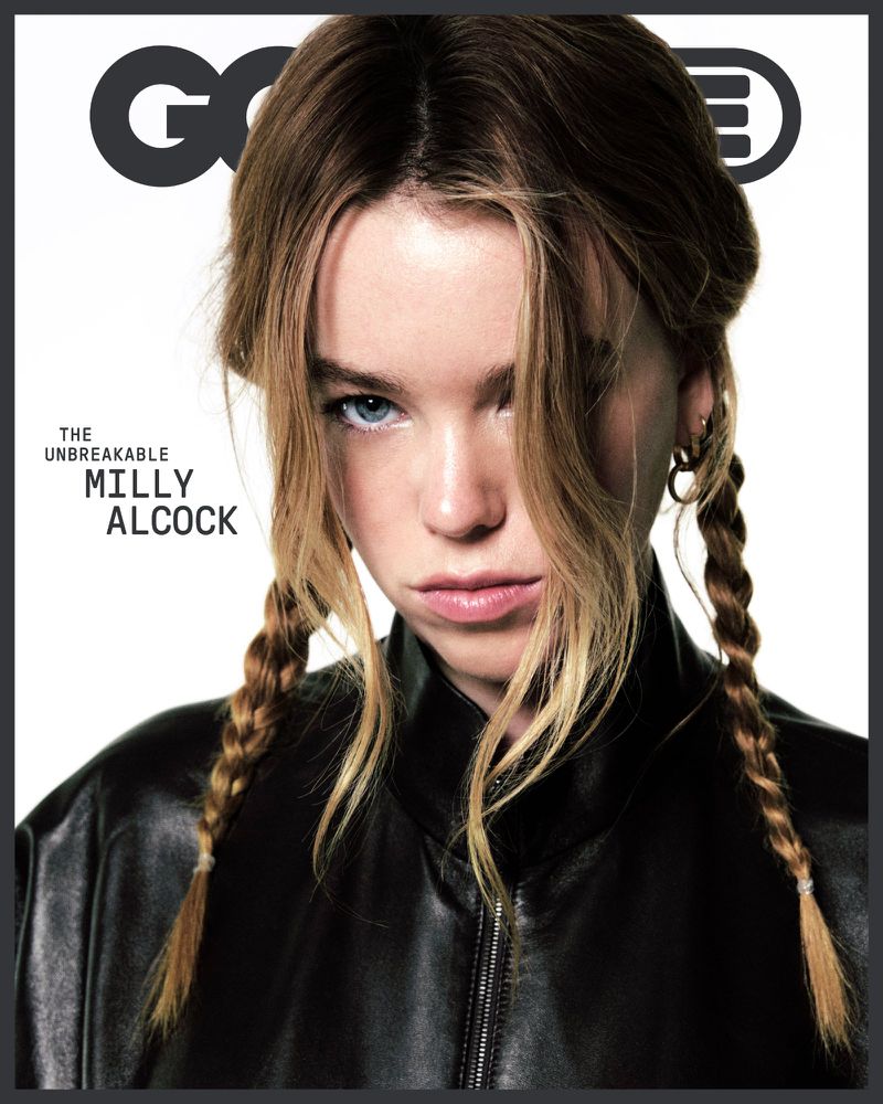 Milly Alcock with braided hair wearing a black leather jacket on a plain white studio background for a magazine cover.