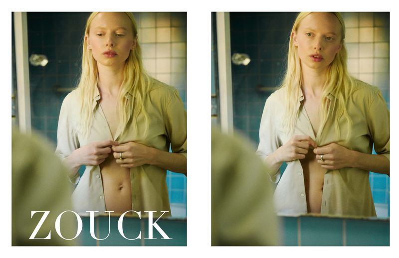 Model India Tuersley wearing an unbuttoned beige shirt looking into a bathroom mirror in a diptych composition.