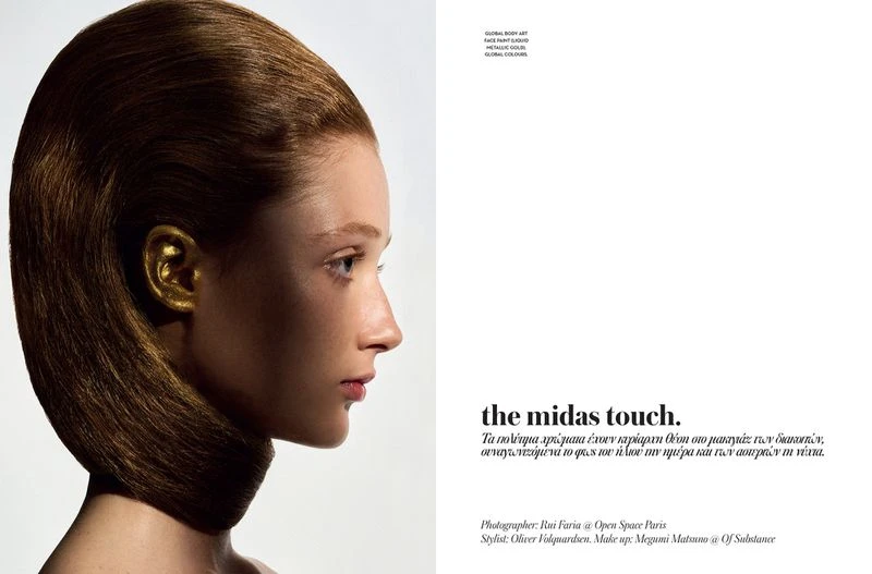 Profile portrait of a fair-skinned adult female model with golden ear, brown hair, neutral expression, and light makeup against a white background.