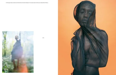 Model draped in sheer black fabric against a warm orange studio backdrop in a fashion editorial spread layout.