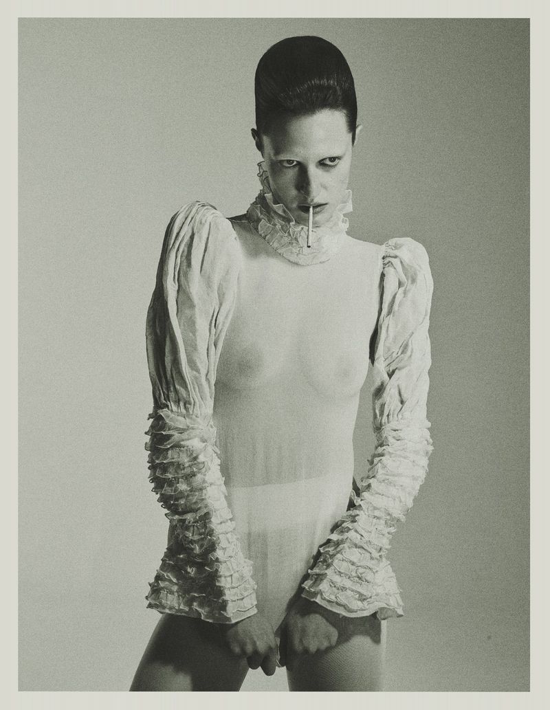 Model Julia Banas in a white ruffled top holding a cigarette for Tidal Magazine, photographed by Edyta Chachulska