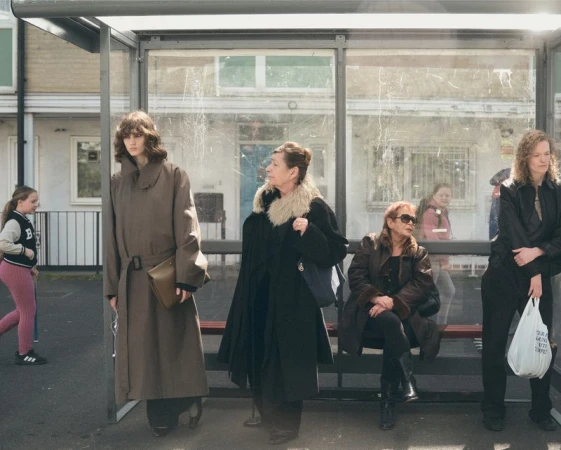 Group of women of varying ages waiting at a glass bus shelter for Albion Magazine editorial