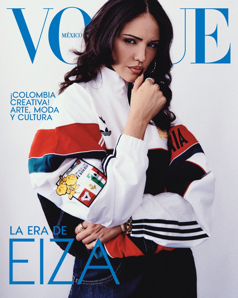 Actor Eiza González posing in a white, red, and black colorblock track jacket on the cover of Vogue Mexico.
