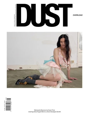 Mariacarla Boscono reclining on the floor in a pastel tulle dress on the cover of Dust Magazine Issue 29.