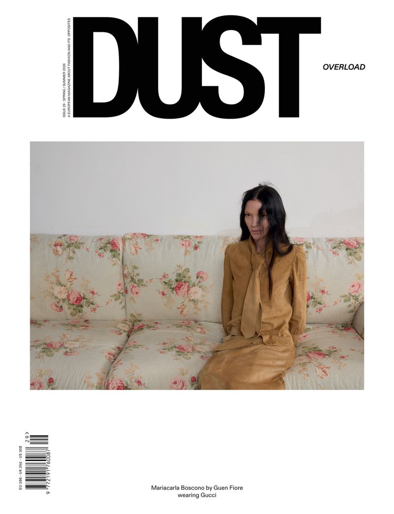 Model Mariacarla Boscono seated on a floral patterned sofa in a magazine cover layout for Dust Magazine