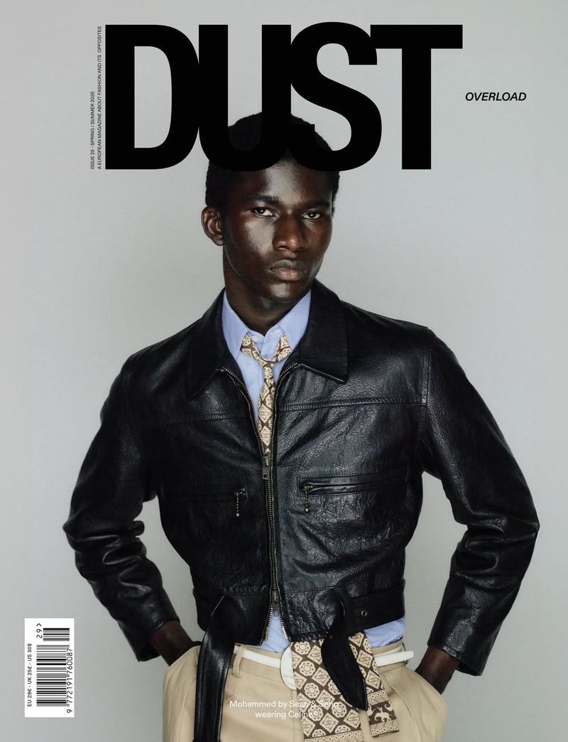 Model Mohammed Banze in a black cropped leather jacket and patterned tie on the cover of Dust Magazine Issue 29.