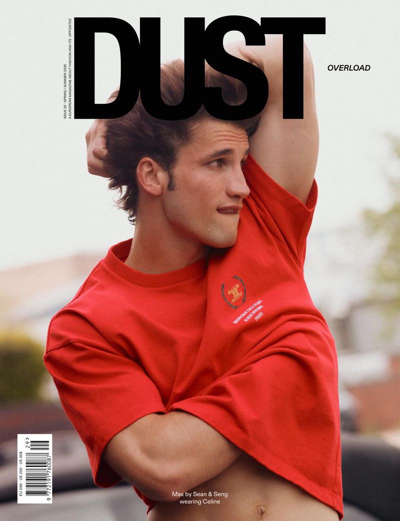 Model Max Knott poses in a red Celine t-shirt with an arm raised on the cover of Dust Magazine Issue 29.