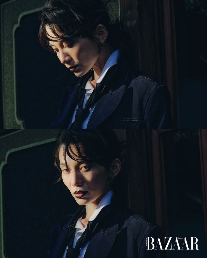 East Asian woman wearing a dark tailored blazer, white shirt, and black tie in a split-frame editorial portrait.