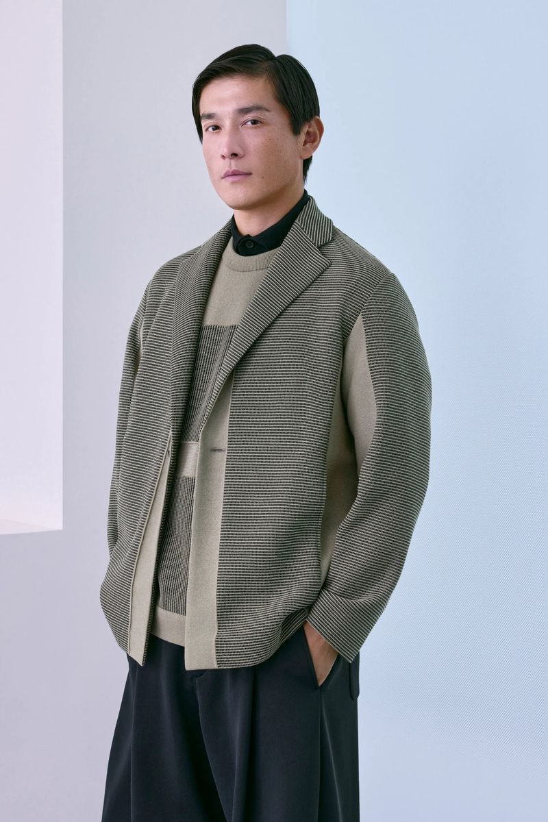 Daisuke Ueda wearing a textured sage green knit jacket layered over a knit sweater and dark trousers for CFCL Men's Lookbook.