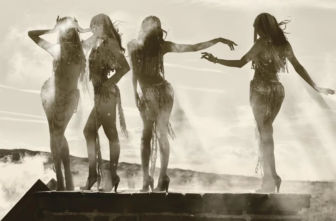 Multiple exposure portrait of Lisa wearing a metallic chained fringe outfit and heels on an outdoor wooden platform.