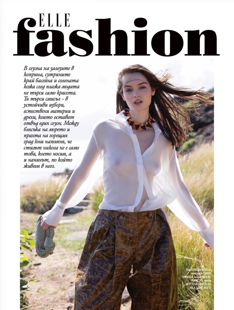 Fashion editorial page from Elle Bulgaria featuring a model outdoors in a sheer white shirt and patterned wide-leg trousers.
