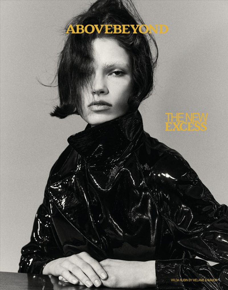 Model Wilda Rubin wearing a glossy black jacket against a plain grey studio backdrop