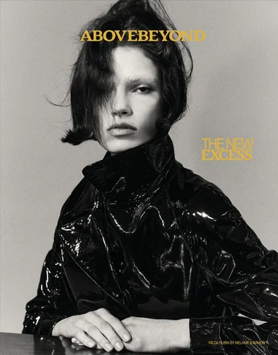 Model Wilda Rubin wearing a glossy black jacket against a plain grey studio backdrop