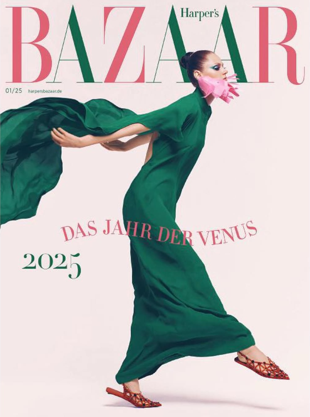 Magazine cover featuring a woman in a flowing green dress and matching shawl, complemented by pink floral accents near the face.