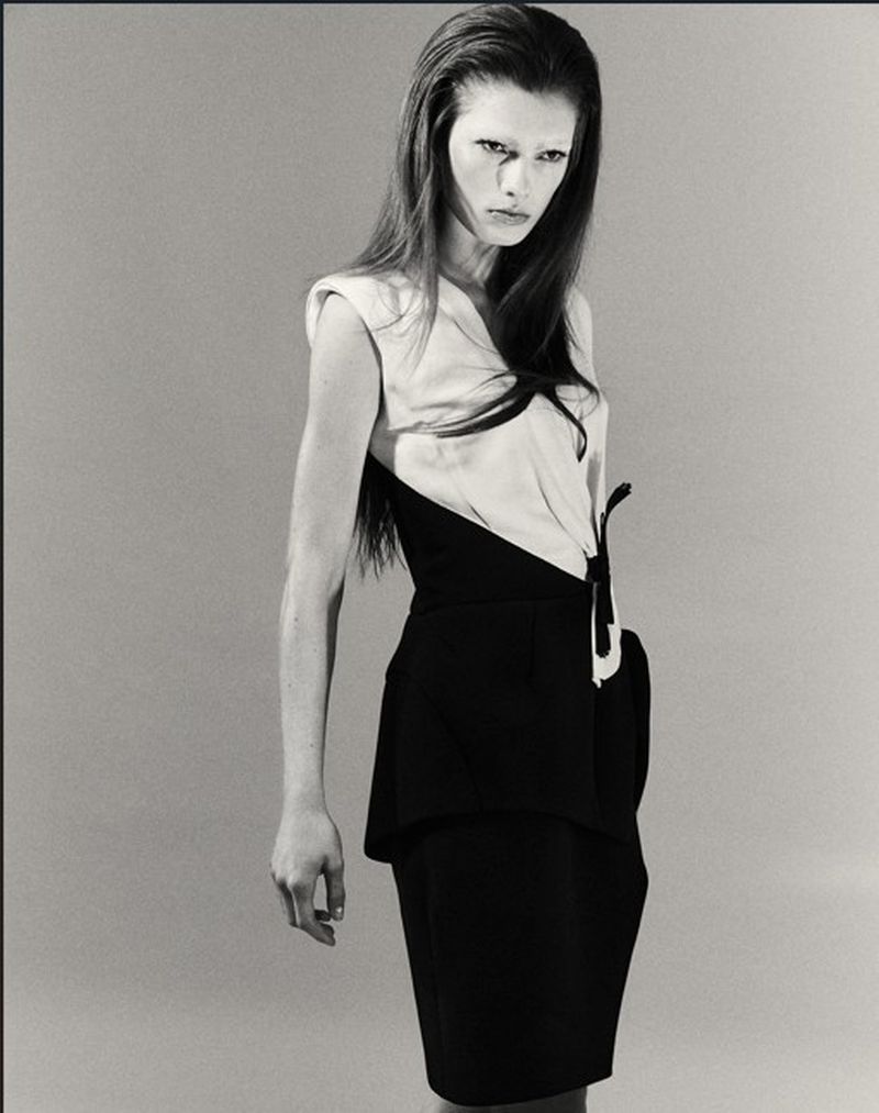 Model Wilda Rubin posing in a structured two-tone black and white sleeveless dress against a neutral studio backdrop.