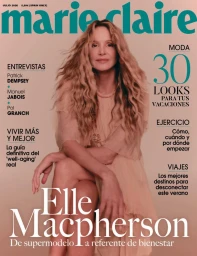 Model Elle Macpherson seated on a seamless backdrop wearing a light dress for Marie Claire Spain cover