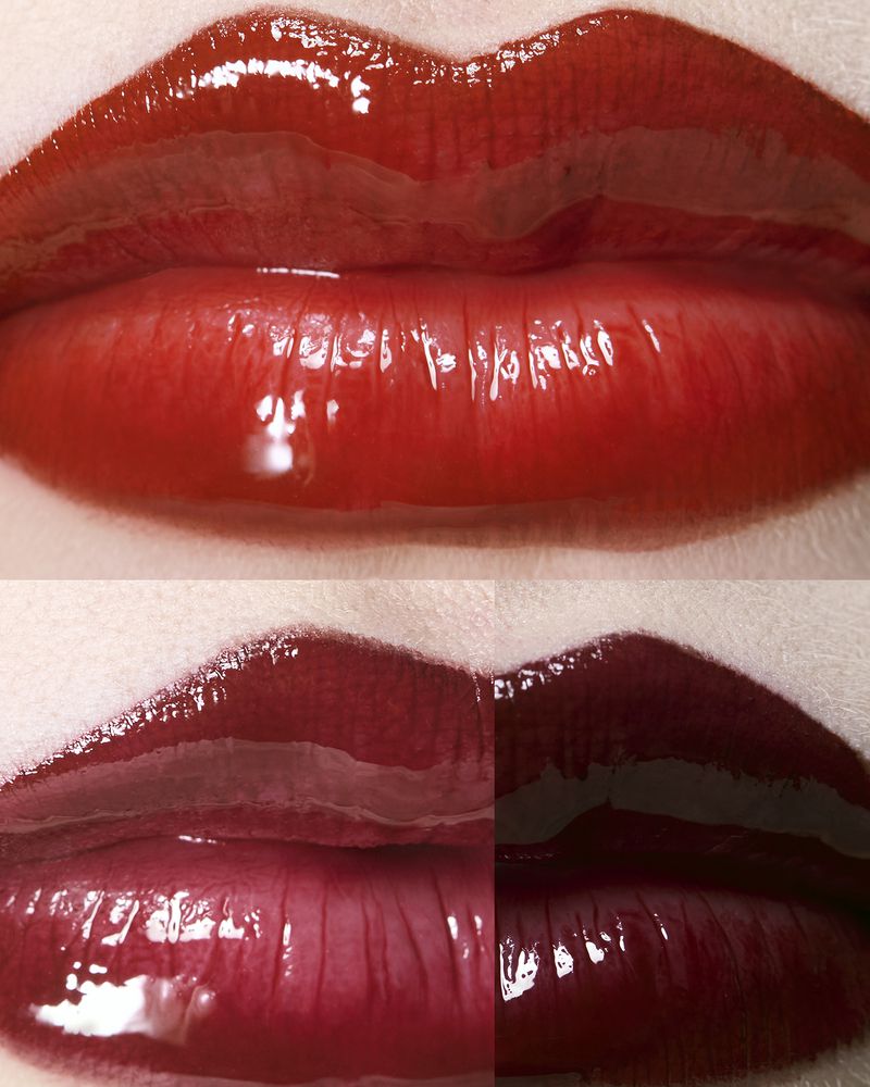 Extreme close-up of glossy lips displaying three swatches of bright red, deep crimson, and dark burgundy lipstick.