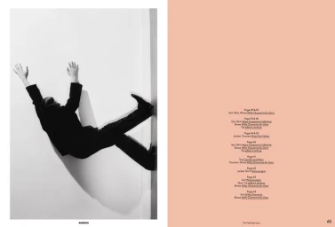 Magazine editorial spread showing a person in a dark suit posing dynamically against a white wall alongside a peach credit page.