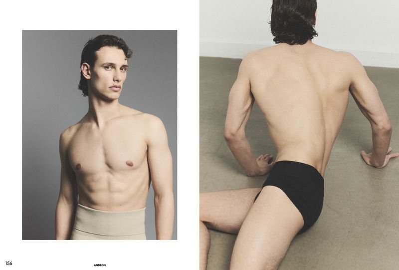 Editorial magazine spread showing a shirtless male model facing forward in a beige band and another model seen from behind in black briefs.