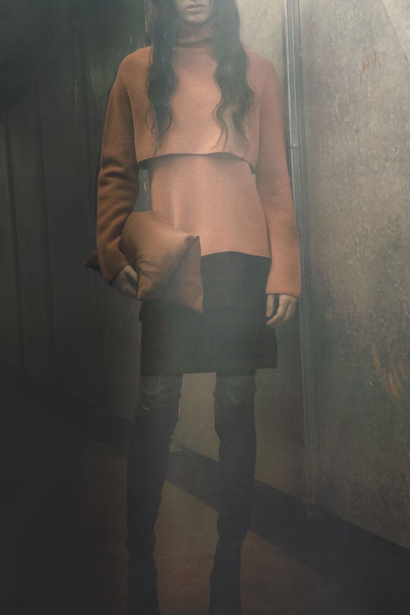 Model Svetlana Lethelier in a peach layered sweater, black skirt, and boots for Christian Wijnants Pre-Fall 2026.