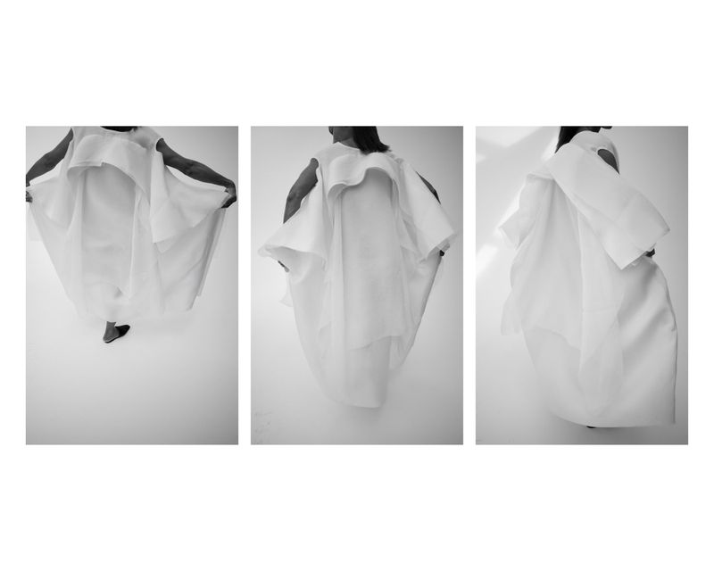 Three-panel black and white lookbook photo of a model wearing an architectural, voluminous white layered dress against a bright background.