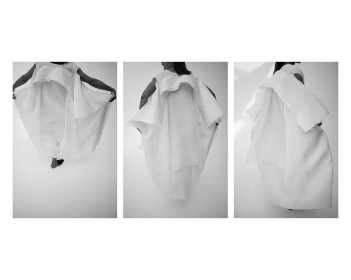 Three-panel black and white lookbook photo of a model wearing an architectural, voluminous white layered dress against a bright background.