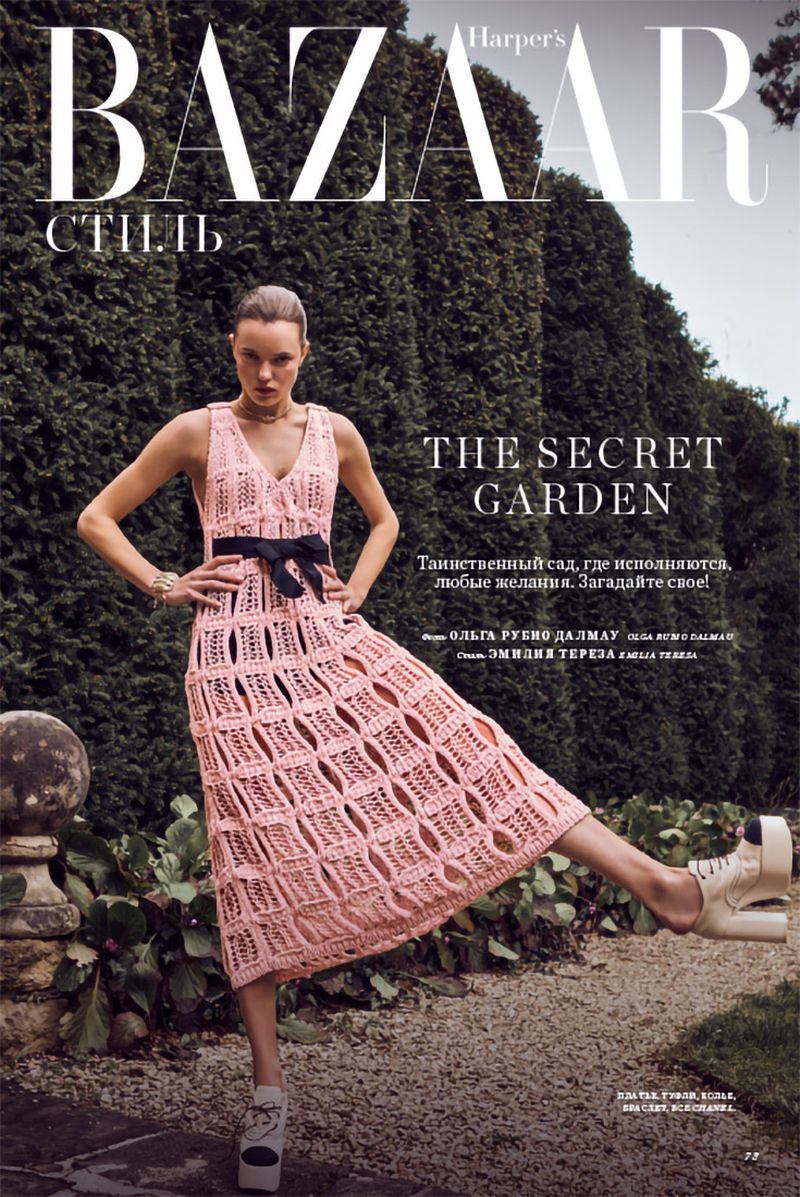 Fashion editorial cover featuring a woman in a pink crochet dress posing in a lush green garden with Harper's Bazaar magazine logo.