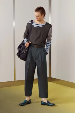 Model Pavlo Stinyk in wide-leg dark trousers, layered knitwear, and teal loafers for Acne Studios S/S 27 Men's Lookbook.