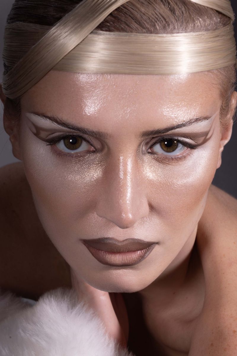 Close-up portrait of model Cali White with avant-garde hair design, dramatic eye makeup, and dark lipstick for Mirror Mirror Magazine.