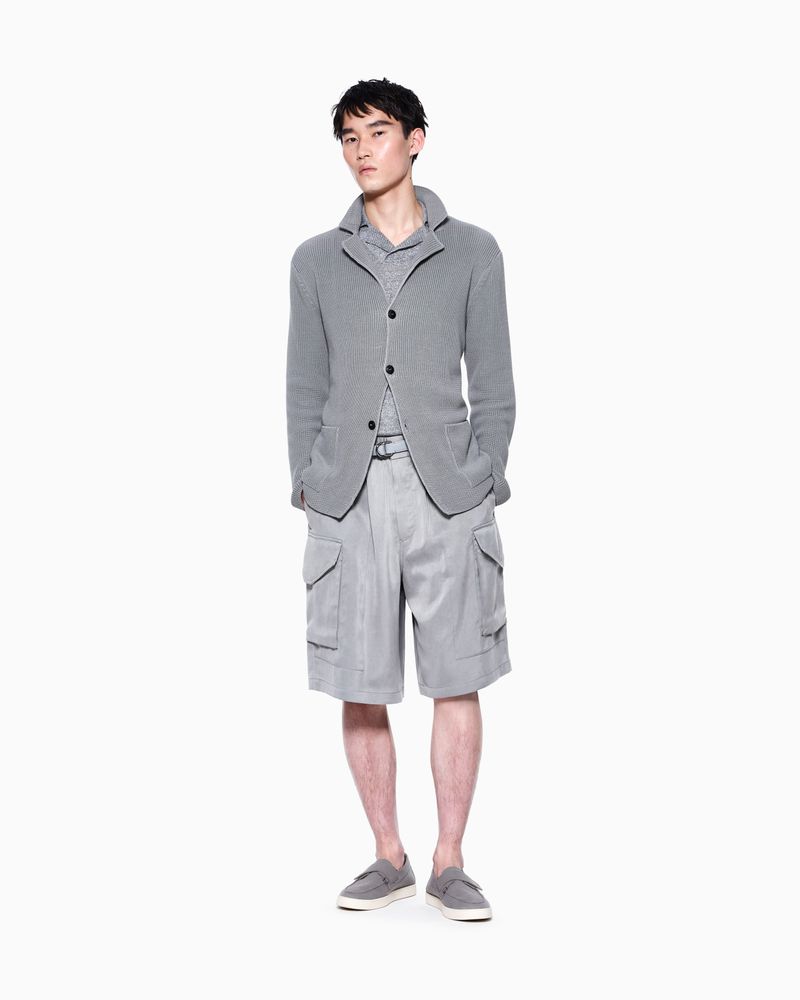 Model Ikko Ohira wears a grey knit jacket, matching cargo shorts, and slip-on shoes against a white studio background.