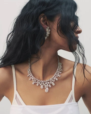 Close-up portrait of model Pooja Mor wearing a diamond necklace and earrings for Financial Times HTSI Magazine